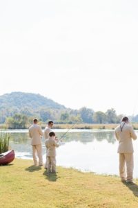groomsmen fishing by lake