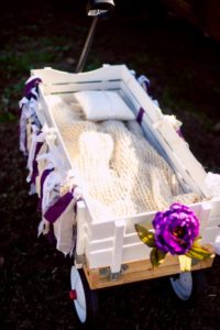 wagon for vintage wedding with purple flowers