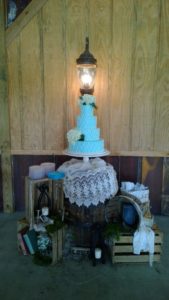 4 tier wedding cake in vintage barn wedding venue