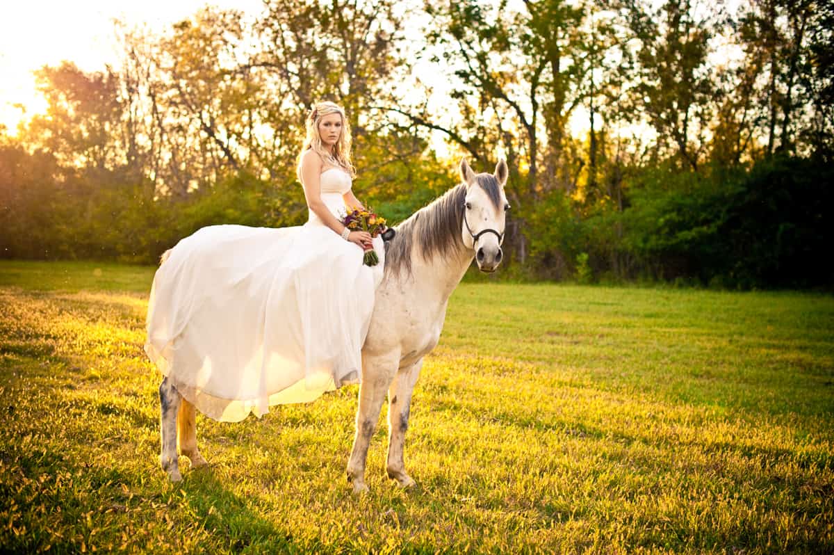 bride on horse at vintage wedding venue in georgia