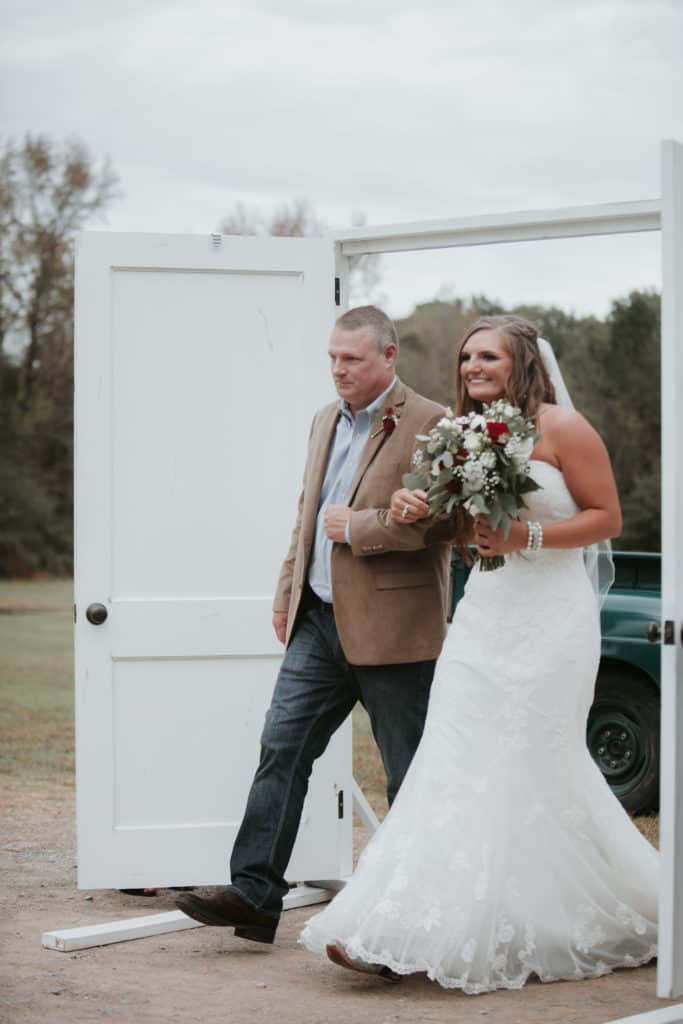 bride and father of the bride walking down the aisle at vintage wedding venue in georgia